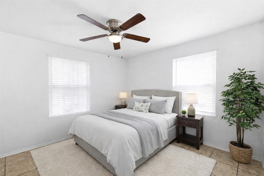 816 Ruidoso Drive Saginaw, TX 76179 - Photo 12 of 22 a bedroom with a large bed and a potted plant