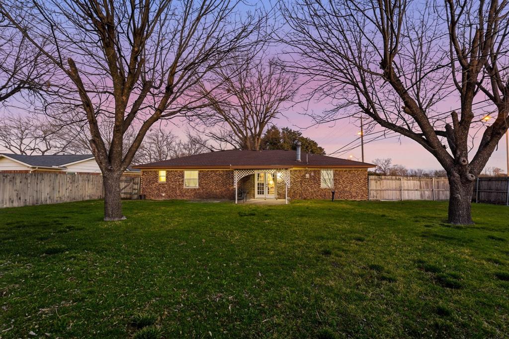 816 Ruidoso Drive Saginaw, TX 76179 - Photo 20 of 22 a front view of a house with a garden