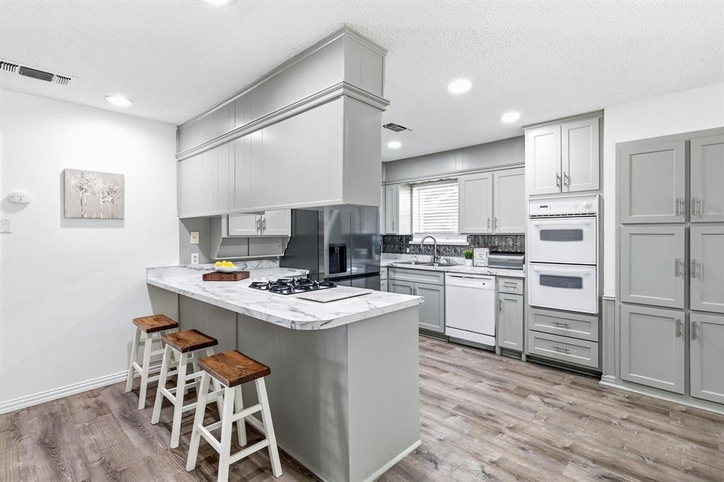 816 Ruidoso Drive Saginaw, TX 76179 - Photo 3 of 22 a kitchen with white cabinets and white appliances