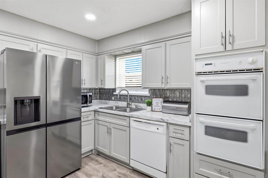 816 Ruidoso Drive Saginaw, TX 76179 - Photo 8 of 22 a kitchen with white cabinets and white appliances