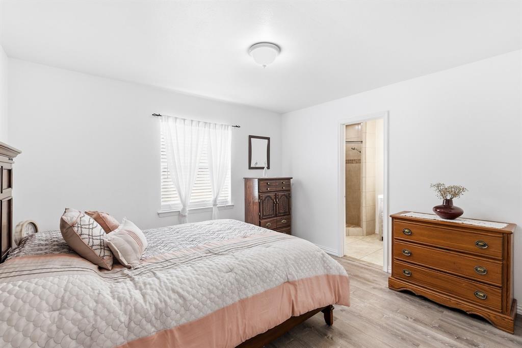 816 Ruidoso Drive Saginaw, TX 76179 - Photo 9 of 22 a bedroom with a bed and a dresser
