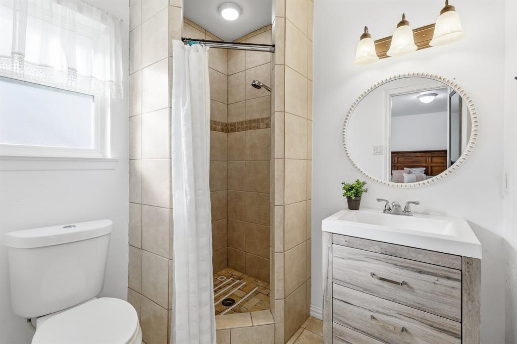 816 Ruidoso Drive Saginaw, TX 76179 - Photo 10 of 22 a bathroom with a toilet sink vanity and mirror