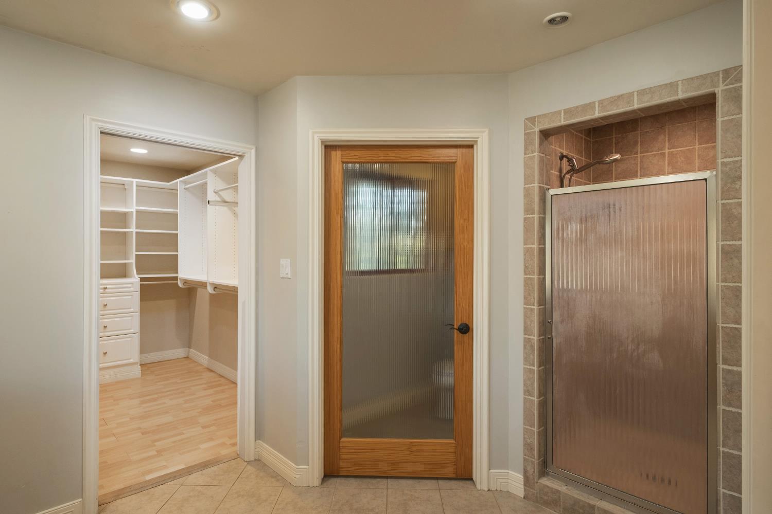 19282 East South Avenue Reedley, CA 93654 - Photo 23 of 33 a view of a bathroom with a glass door and shower