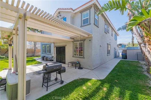 a view of a patio with couches table and chairs and potted plants