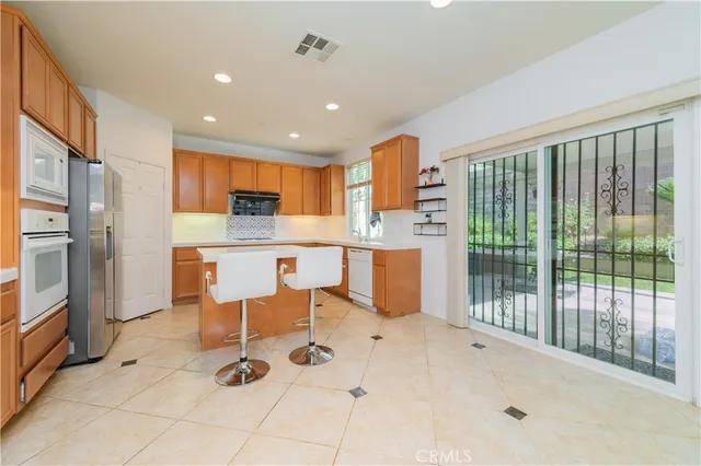 a view of kitchen with stainless steel appliances cabinets
