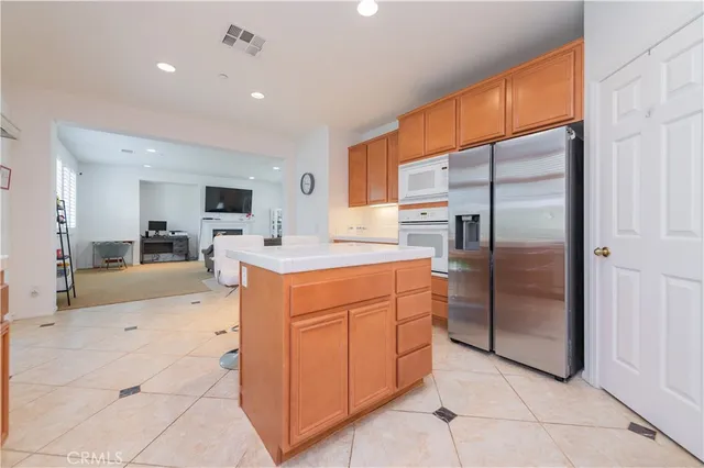 a kitchen with stainless steel appliances a refrigerator sink and cabinets