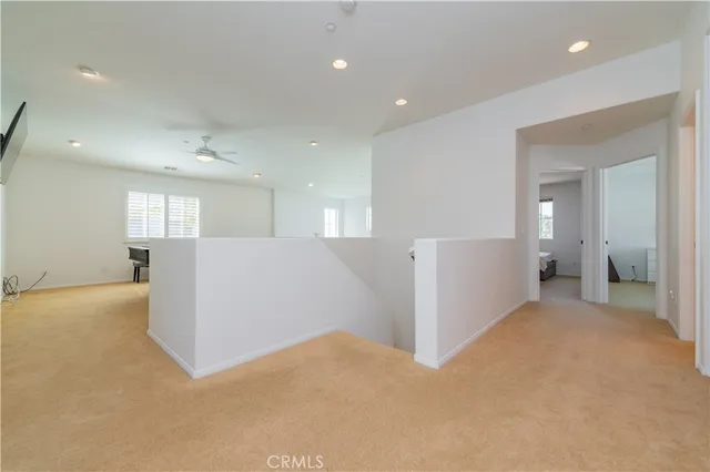 a view of a big room with windows and chandelier