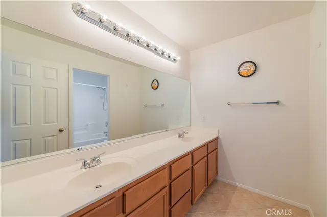 a bathroom with a double vanity sink and mirror