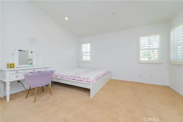 a spacious bedroom with a bed and a table