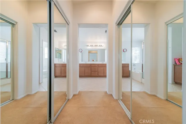 a view of a hallway with wooden floor and living room