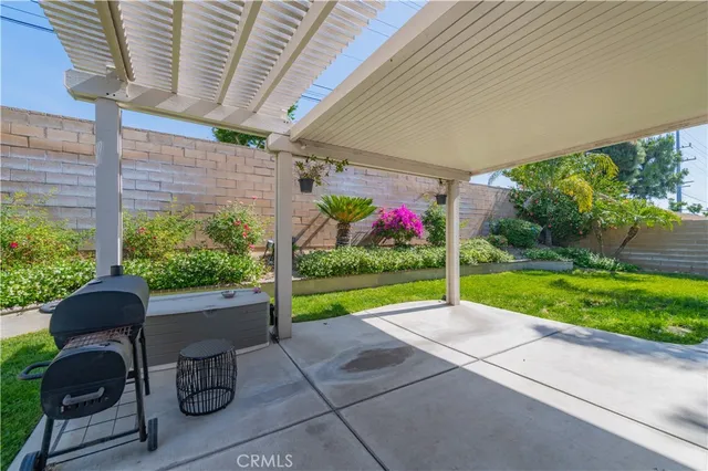 a view of a porch with furniture and a yard