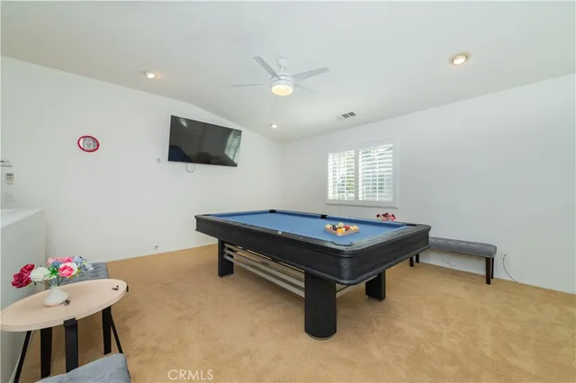 a room with furniture pool table and flat screen tv