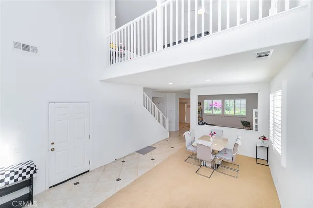 a living room with furniture and a baby crib