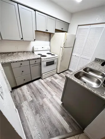 a kitchen with a sink stove and refrigerator