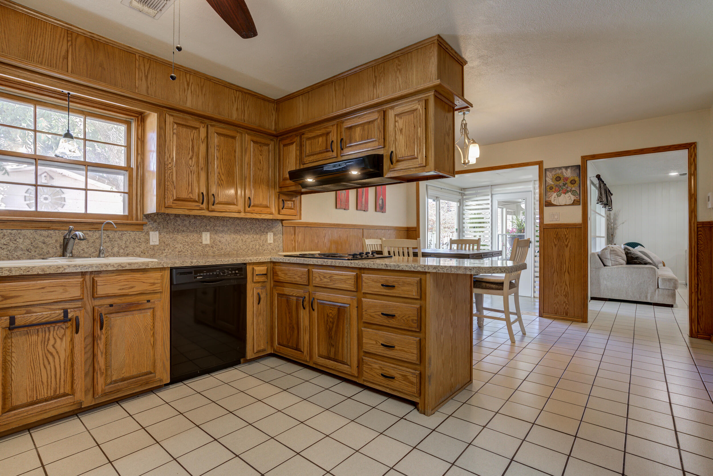 2120 53rd Street Lubbock, TX 79412 - Photo 12 of 32 a kitchen with stainless steel appliances granite countertop a sink and cabinets