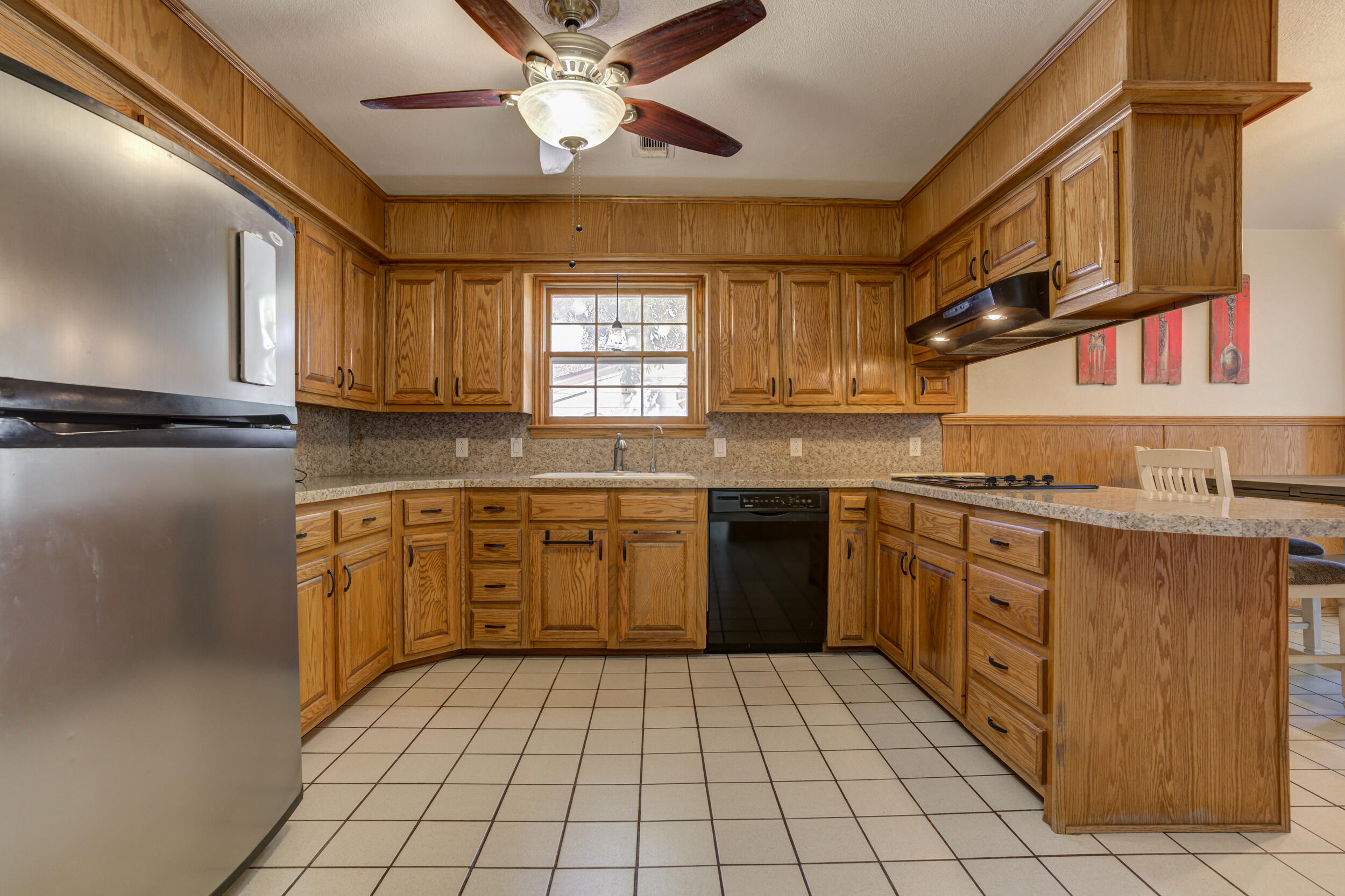 2120 53rd Street Lubbock, TX 79412 - Photo 13 of 32 a kitchen with stainless steel appliances granite countertop a sink and cabinets
