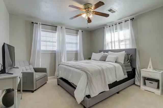 a bedroom with a bed couch and window