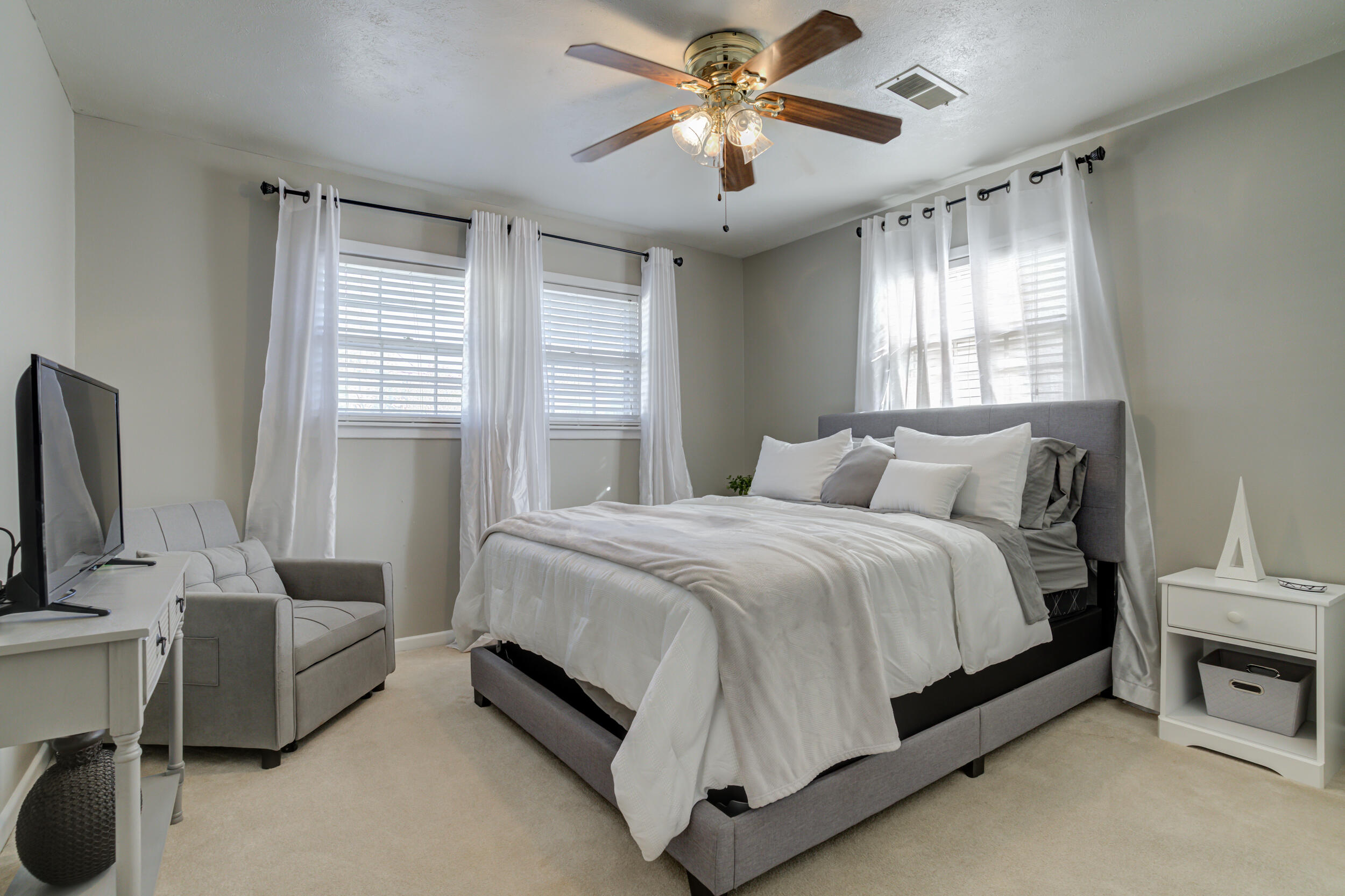 2120 53rd Street Lubbock, TX 79412 - Photo 18 of 32 a bedroom with a bed couch and window