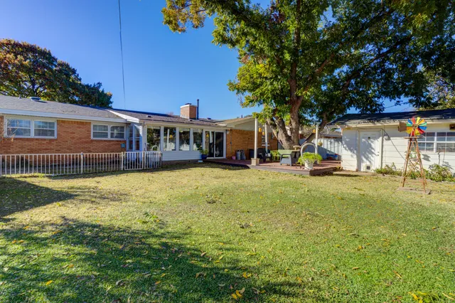 a view of a house with a yard patio and swimming pool