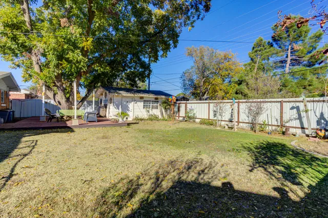 a view of yard with swimming pool and seating space
