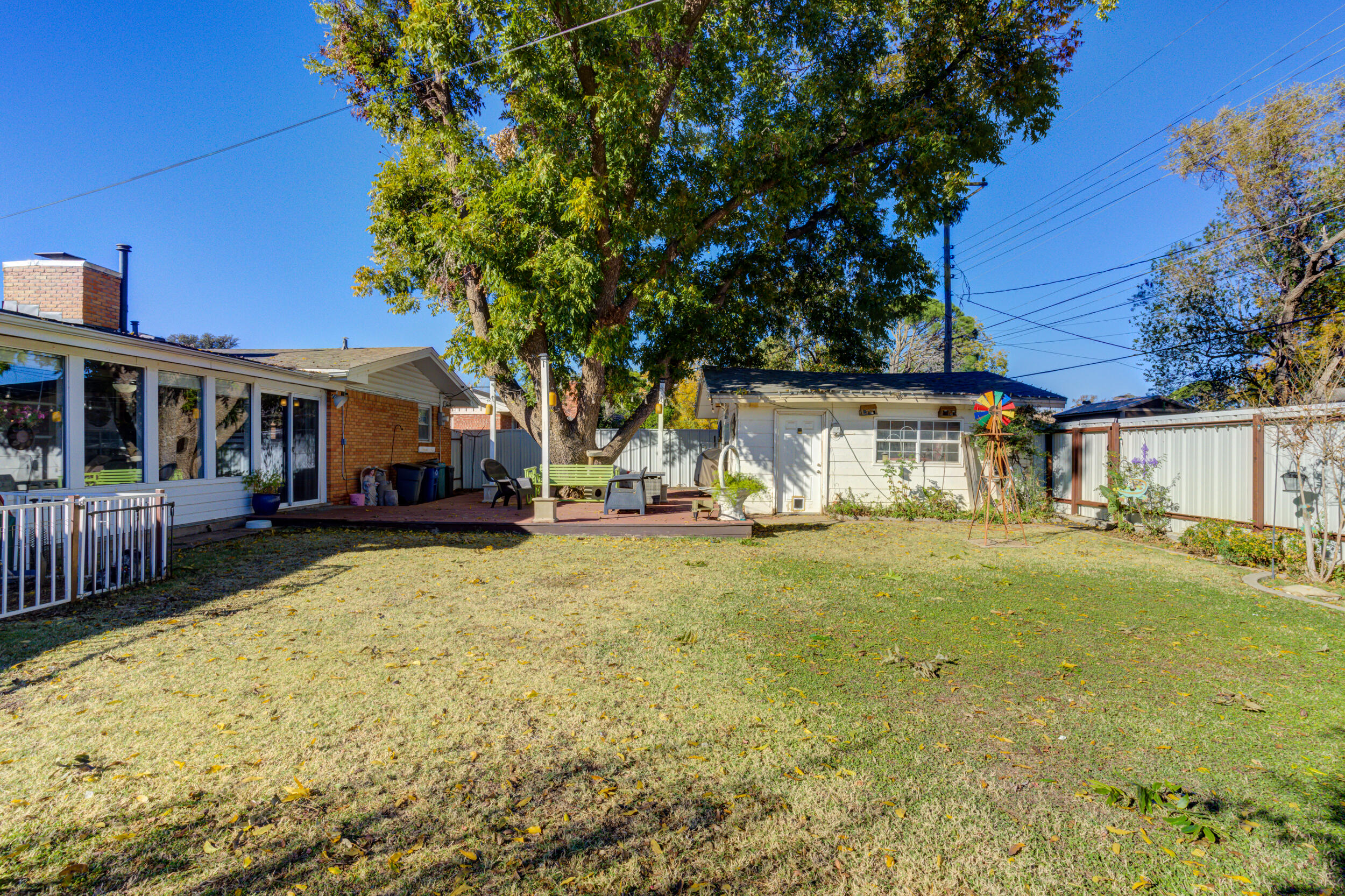 2120 53rd Street Lubbock, TX 79412 - Photo 30 of 32 a view of a yard with a house and a large tree