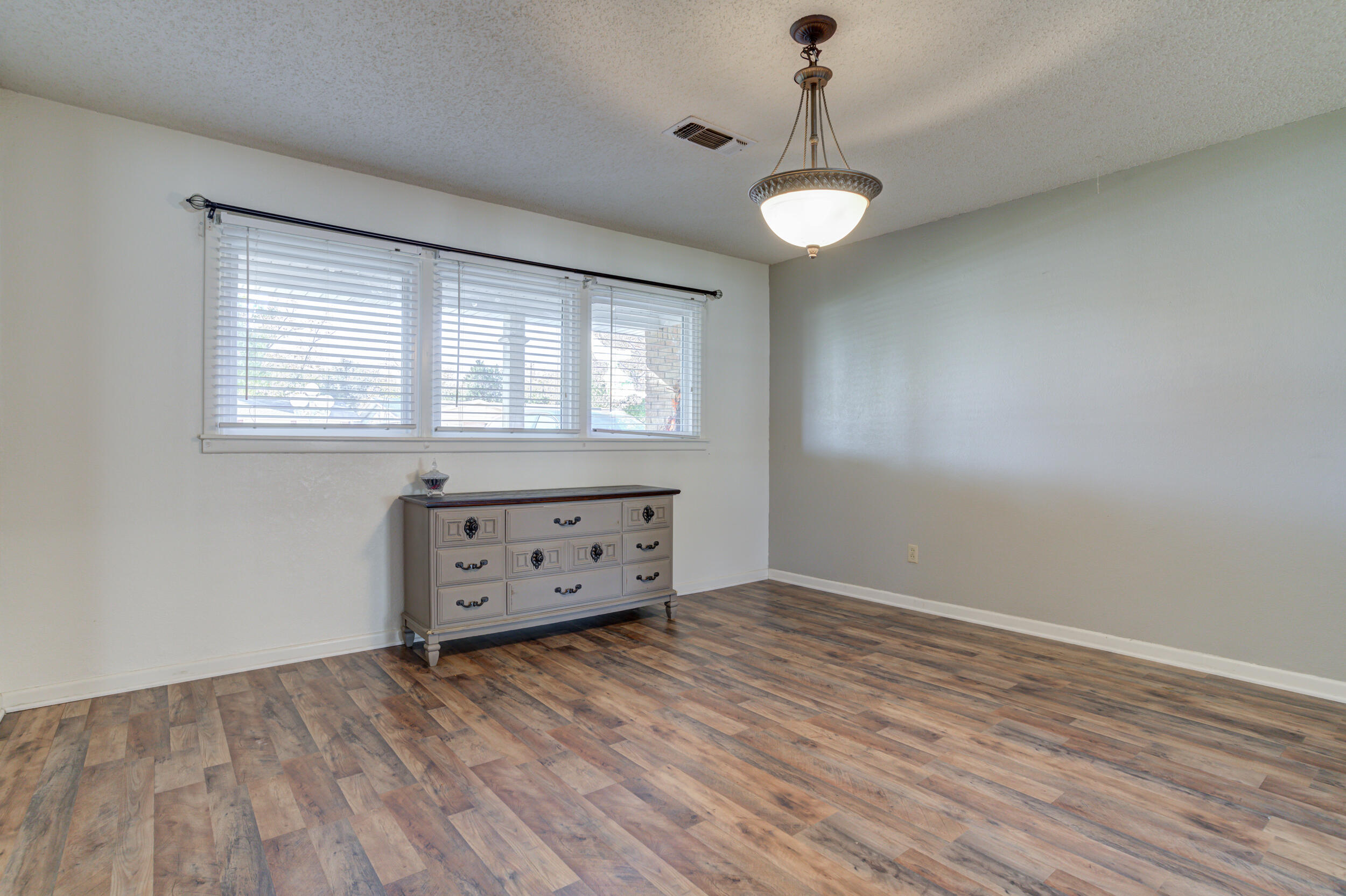 2120 53rd Street Lubbock, TX 79412 - Photo 4 of 32 wooden floor in an empty room with a window