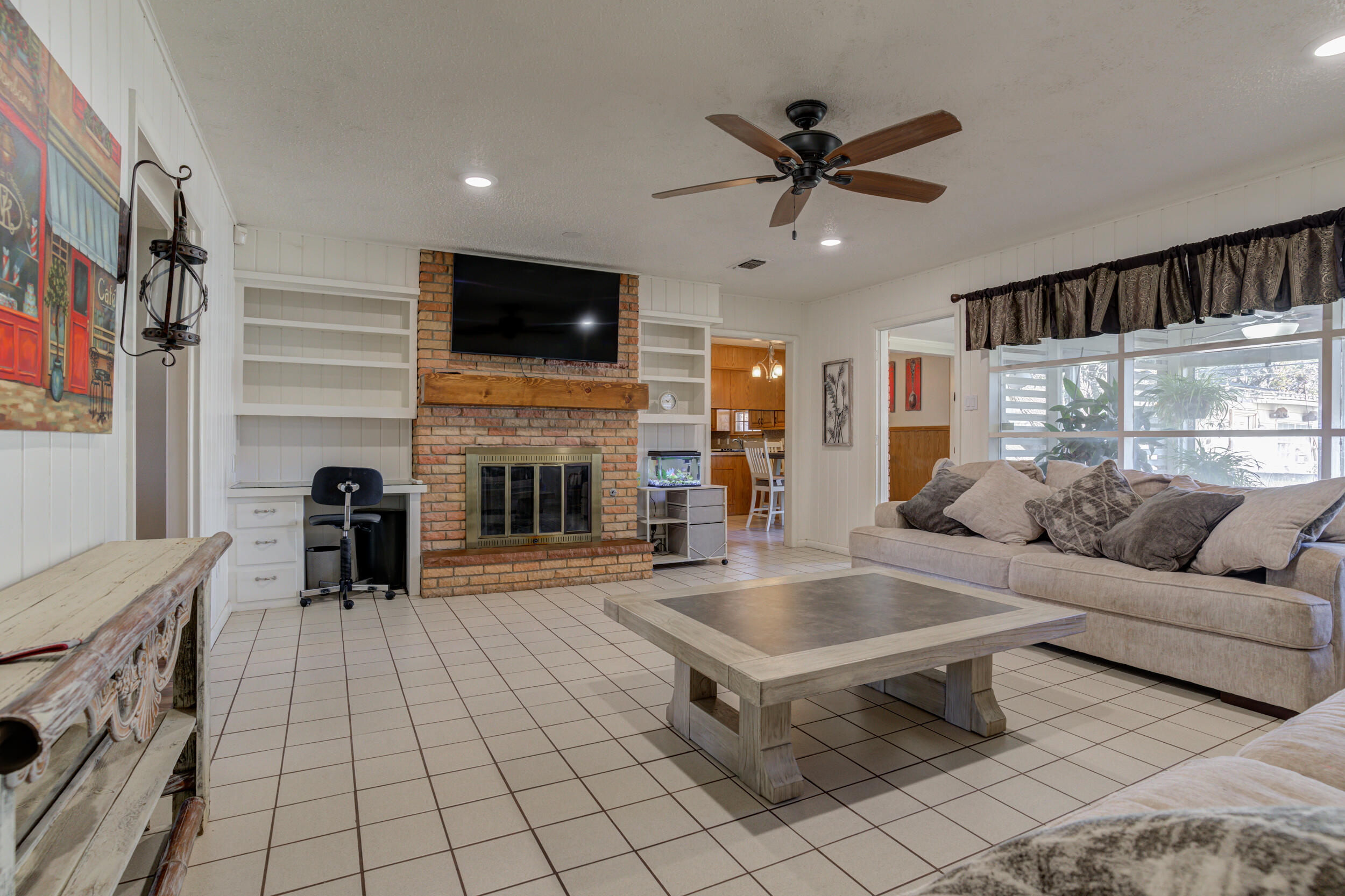 2120 53rd Street Lubbock, TX 79412 - Photo 7 of 32 a living room with furniture and a fireplace