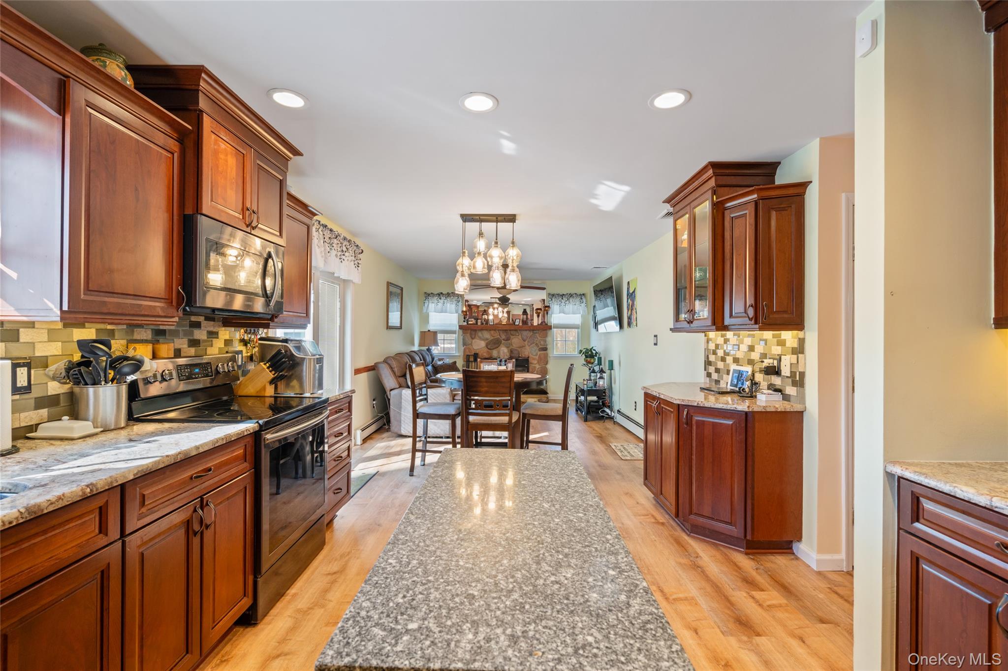 194 Miller Place Road Miller Place, NY 11764 - Photo 13 of 50 a kitchen with stainless steel appliances granite countertop sink stove and refrigerator