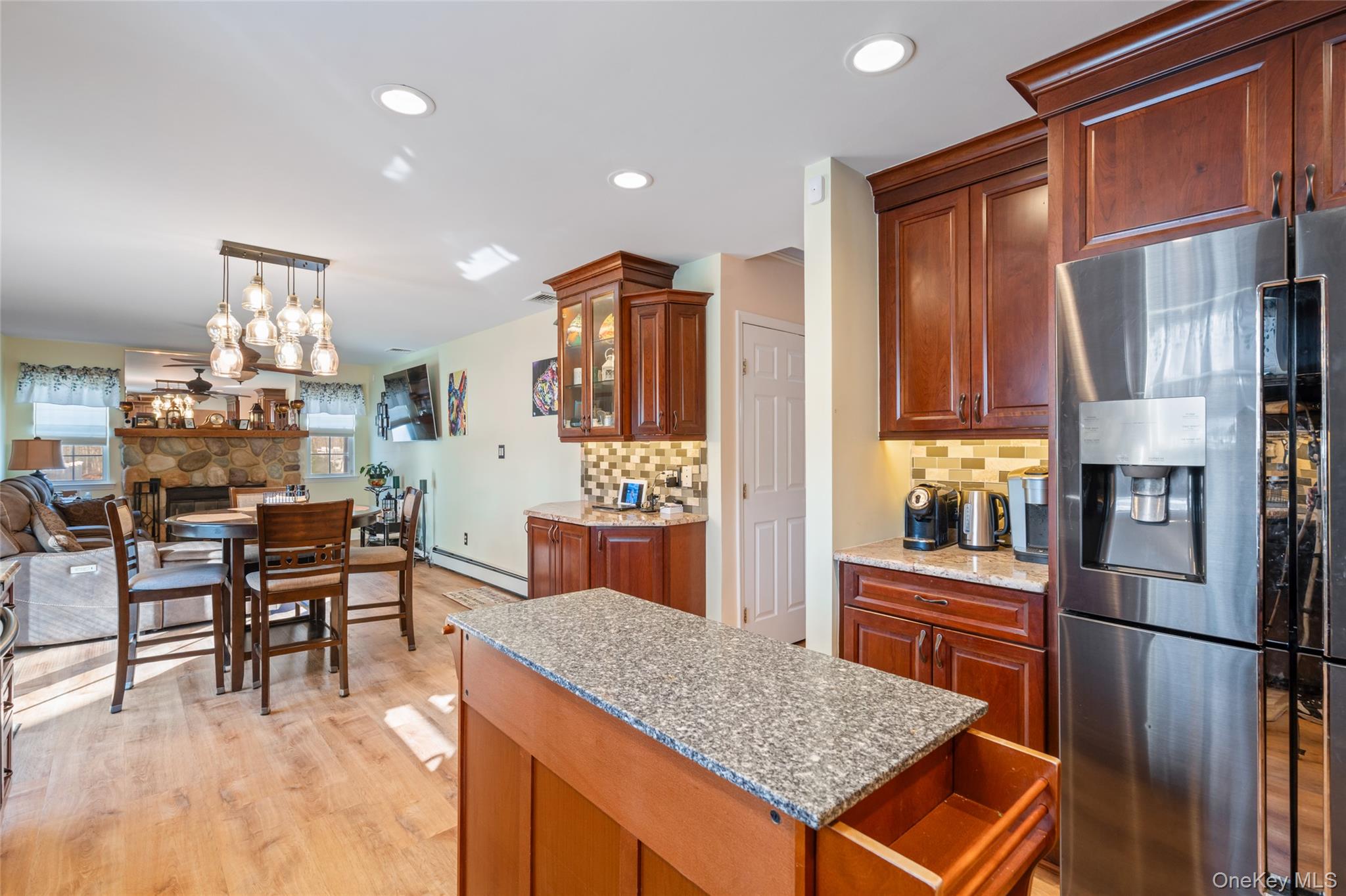 194 Miller Place Road Miller Place, NY 11764 - Photo 14 of 50 a kitchen with stainless steel appliances granite countertop a refrigerator a stove and a wooden cabinets