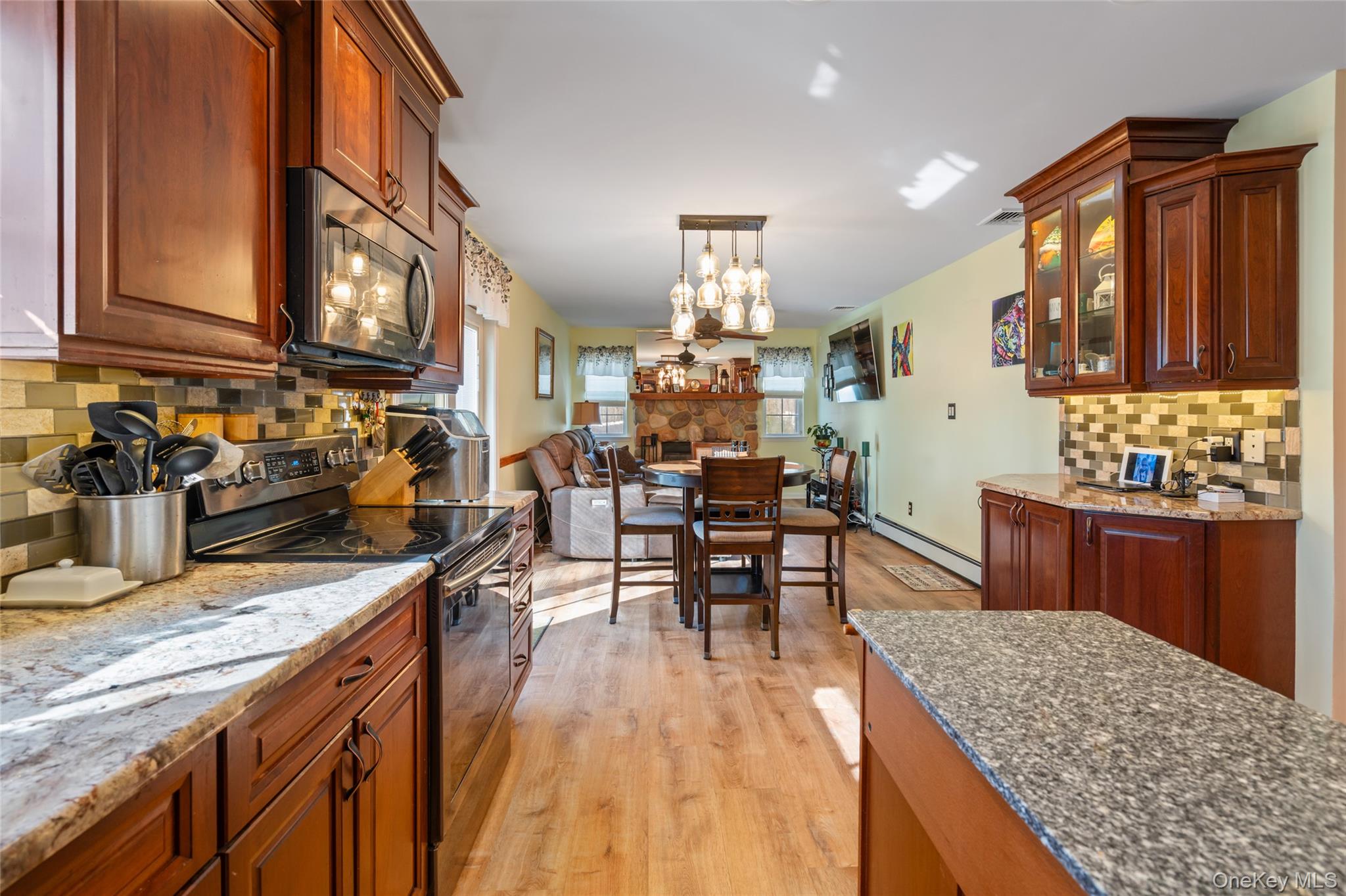 194 Miller Place Road Miller Place, NY 11764 - Photo 15 of 50 a kitchen with stainless steel appliances granite countertop sink stove top oven and cabinets