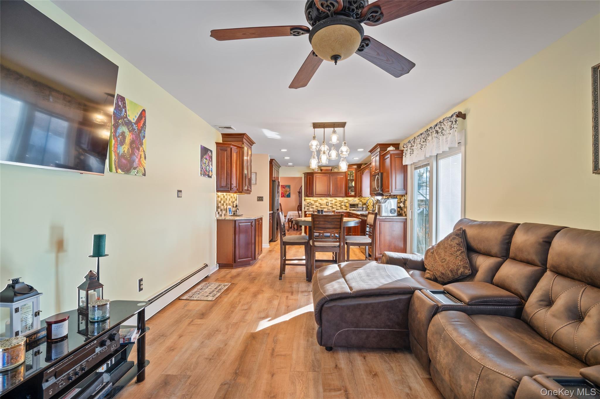 194 Miller Place Road Miller Place, NY 11764 - Photo 18 of 50 a living room with furniture ceiling fan and a wooden floor