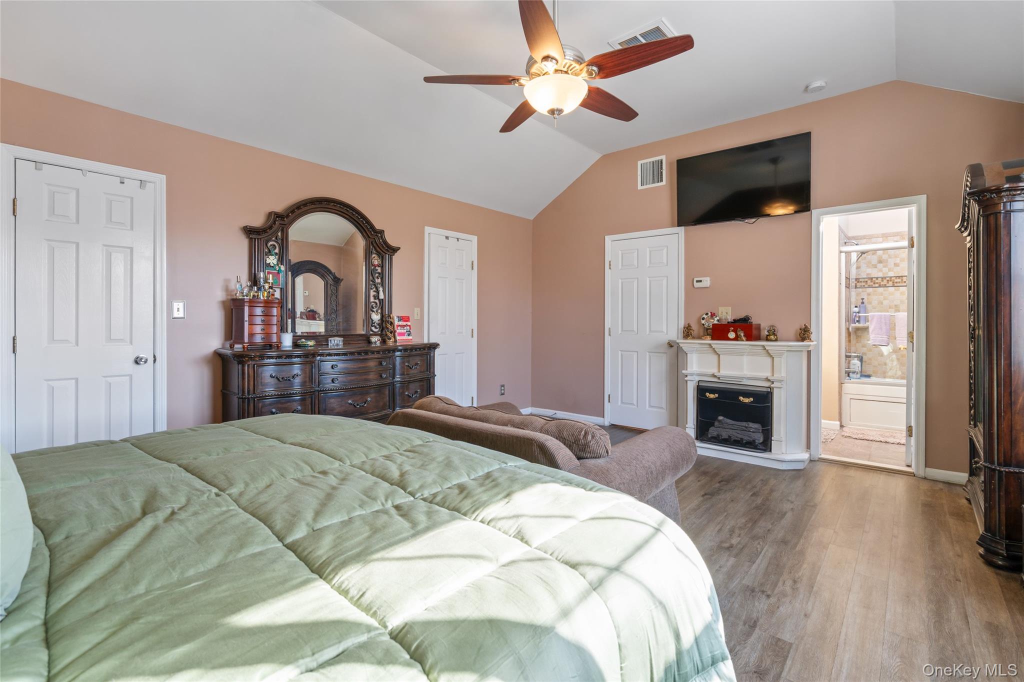 194 Miller Place Road Miller Place, NY 11764 - Photo 22 of 50 a bedroom with a bed and a fireplace