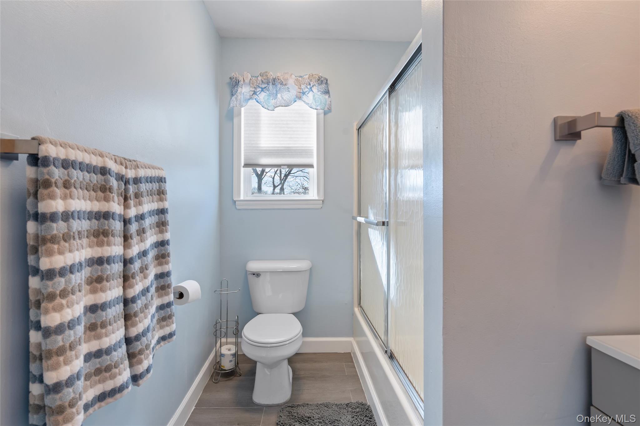 194 Miller Place Road Miller Place, NY 11764 - Photo 27 of 50 a white toilet sitting next to a shower curtain