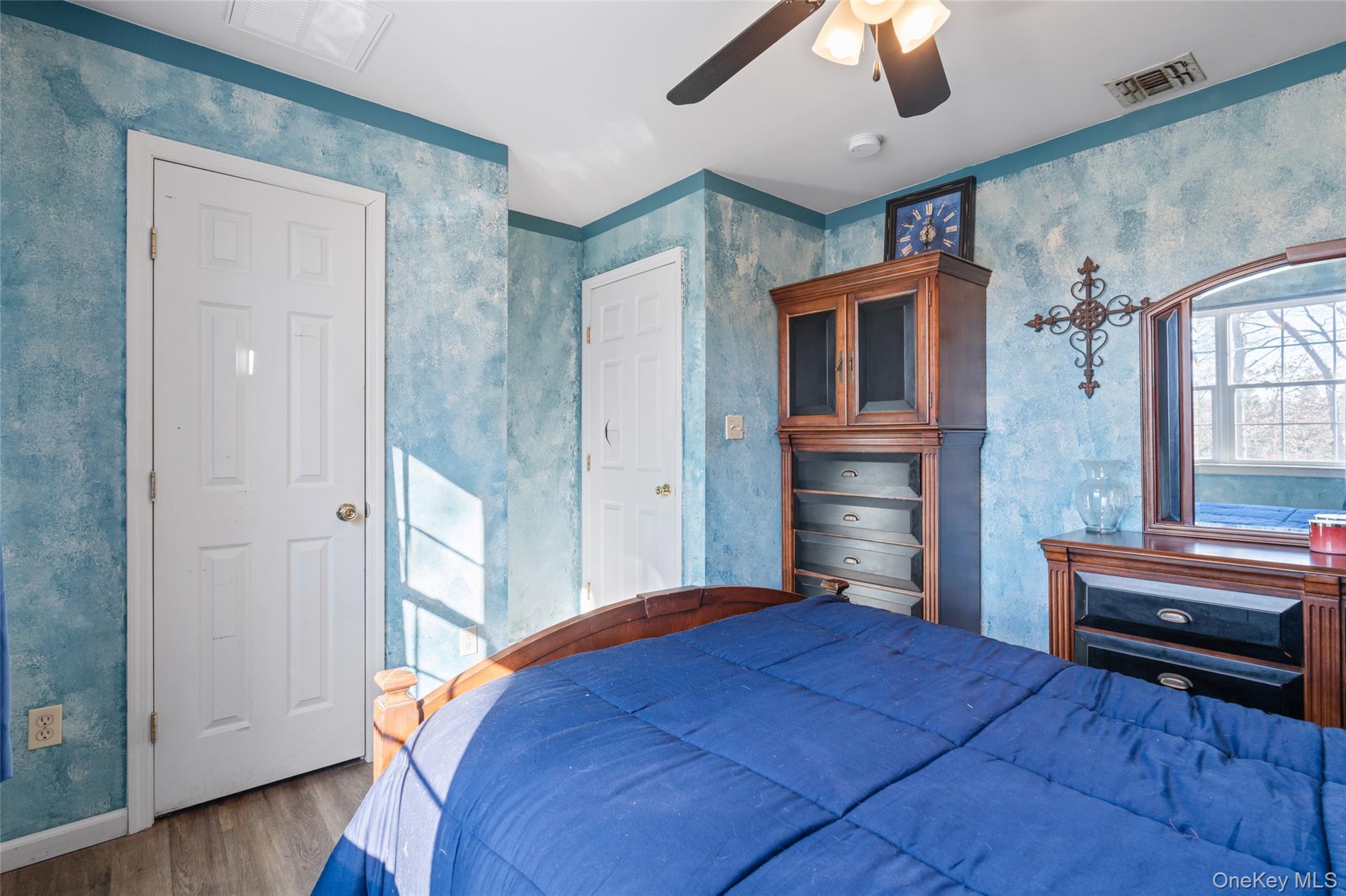 194 Miller Place Road Miller Place, NY 11764 - Photo 29 of 50 a bedroom with a bed and a chandelier