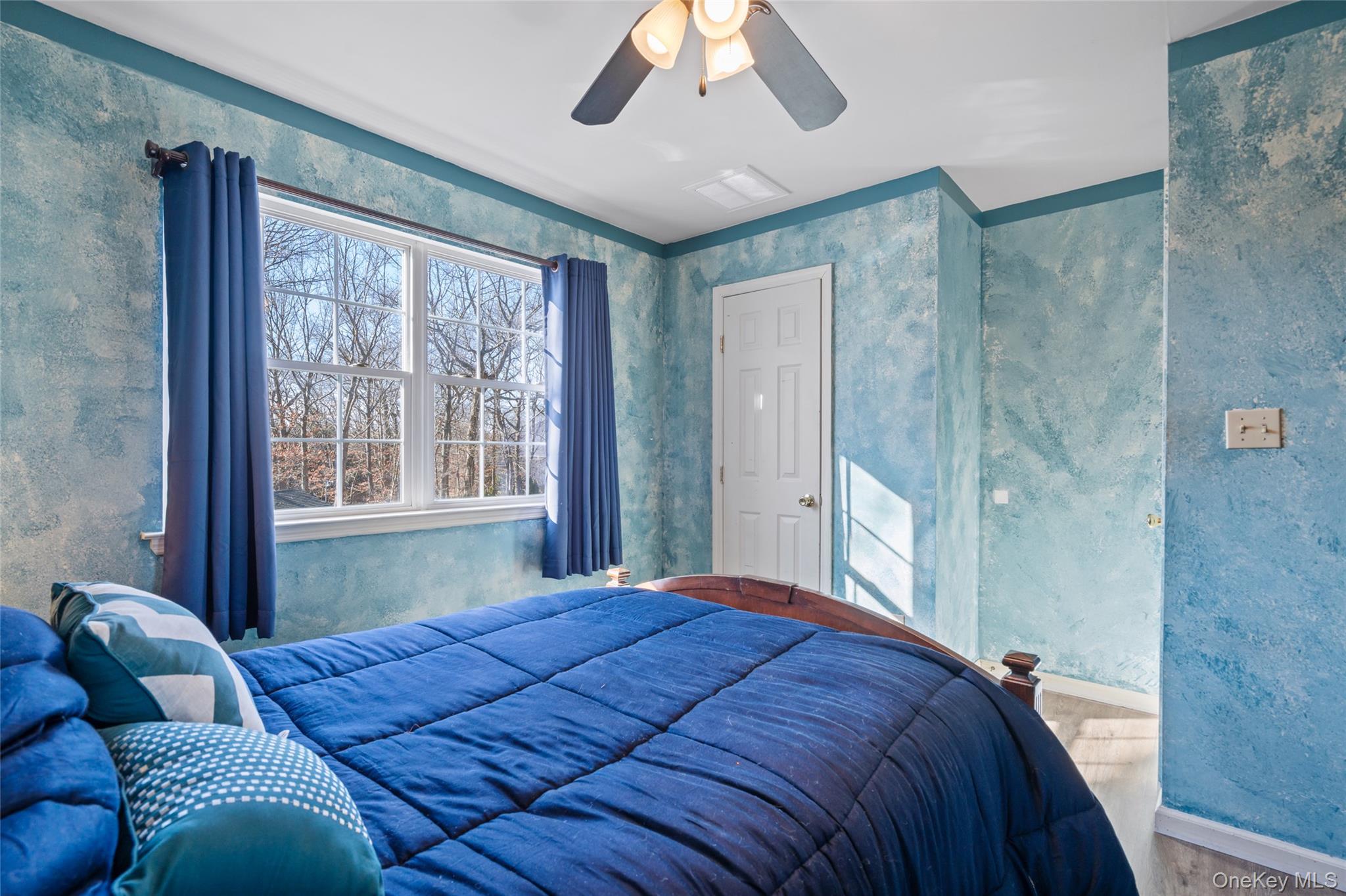 194 Miller Place Road Miller Place, NY 11764 - Photo 30 of 50 a bedroom with a large bed and a large window