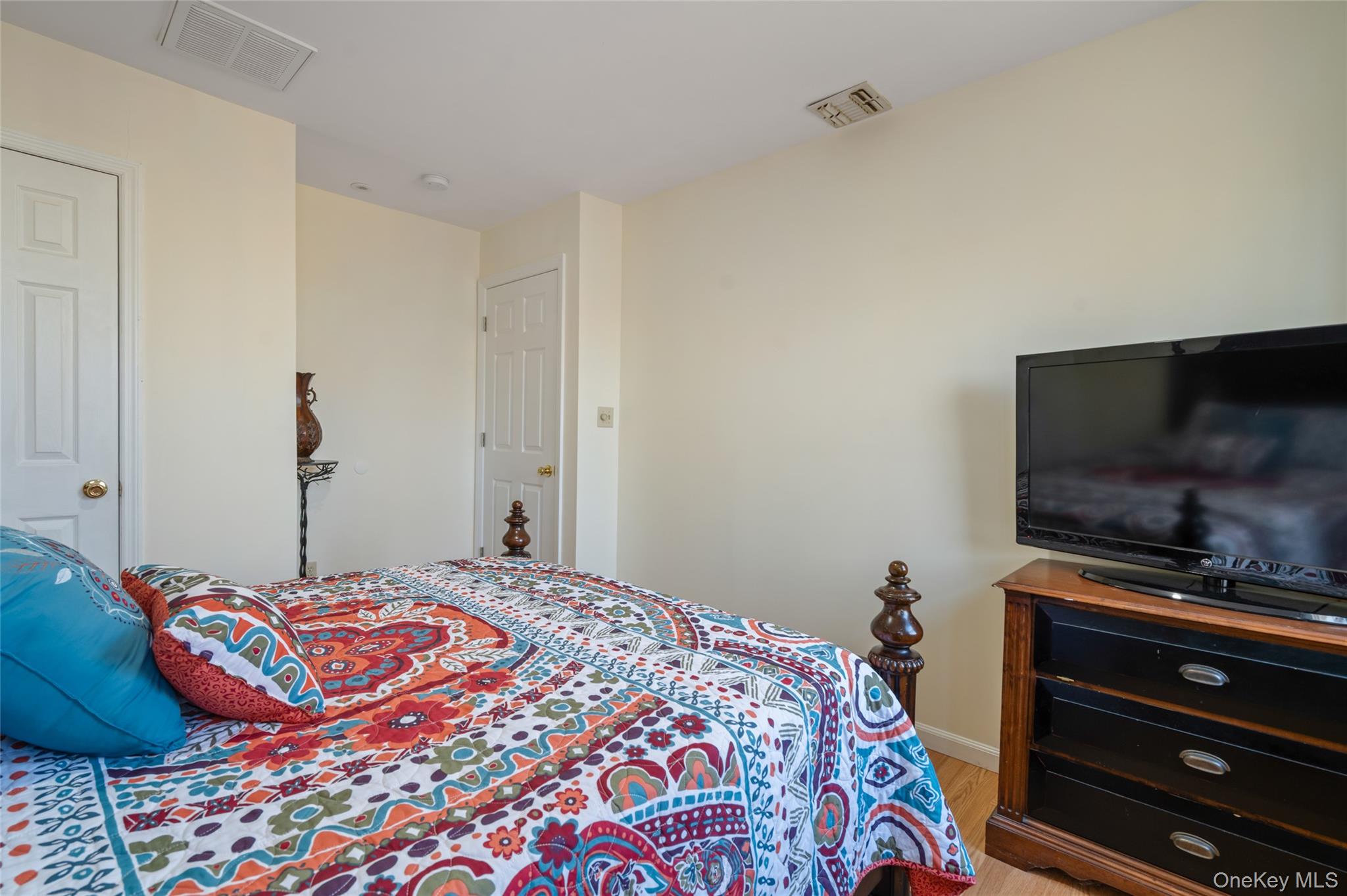 194 Miller Place Road Miller Place, NY 11764 - Photo 32 of 50 a bedroom with a bed and a flat screen tv