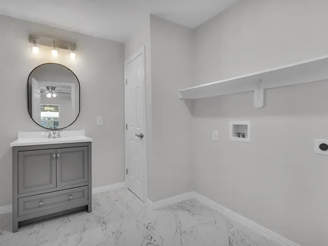 an empty room with mirror on the wall