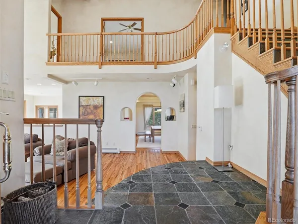 a living room with furniture a rug and a chandelier