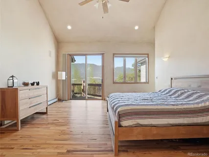 a bedroom with a large bed and a window
