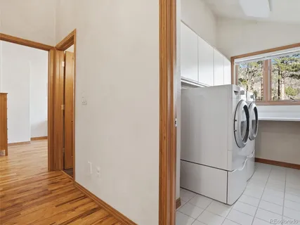 a view of a storage and utility room with washer and dryer