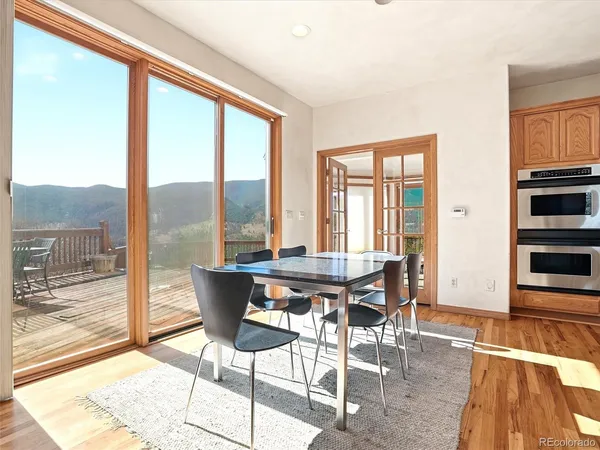 a dining room with furniture and wooden floor