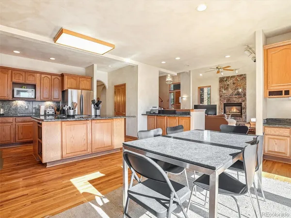 a kitchen with granite countertop kitchen island cabinets and refrigerator