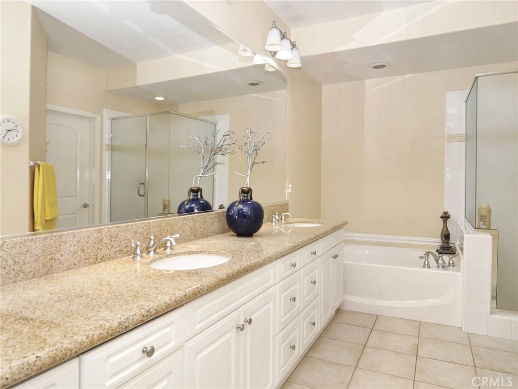 135 Pathway Irvine, CA 92618 - Photo 9 of 12 a bathroom with a granite countertop sink mirror and bathtub
