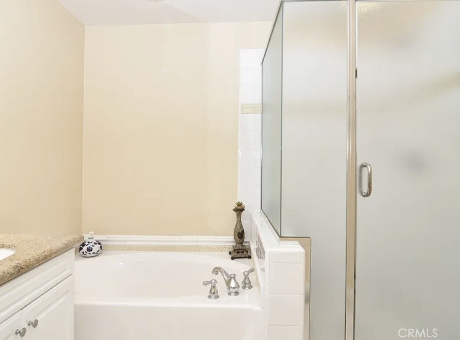 135 Pathway Irvine, CA 92618 - Photo 10 of 12 a bathroom with a bathtub and a shower