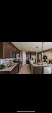 a kitchen with kitchen island sink and stove