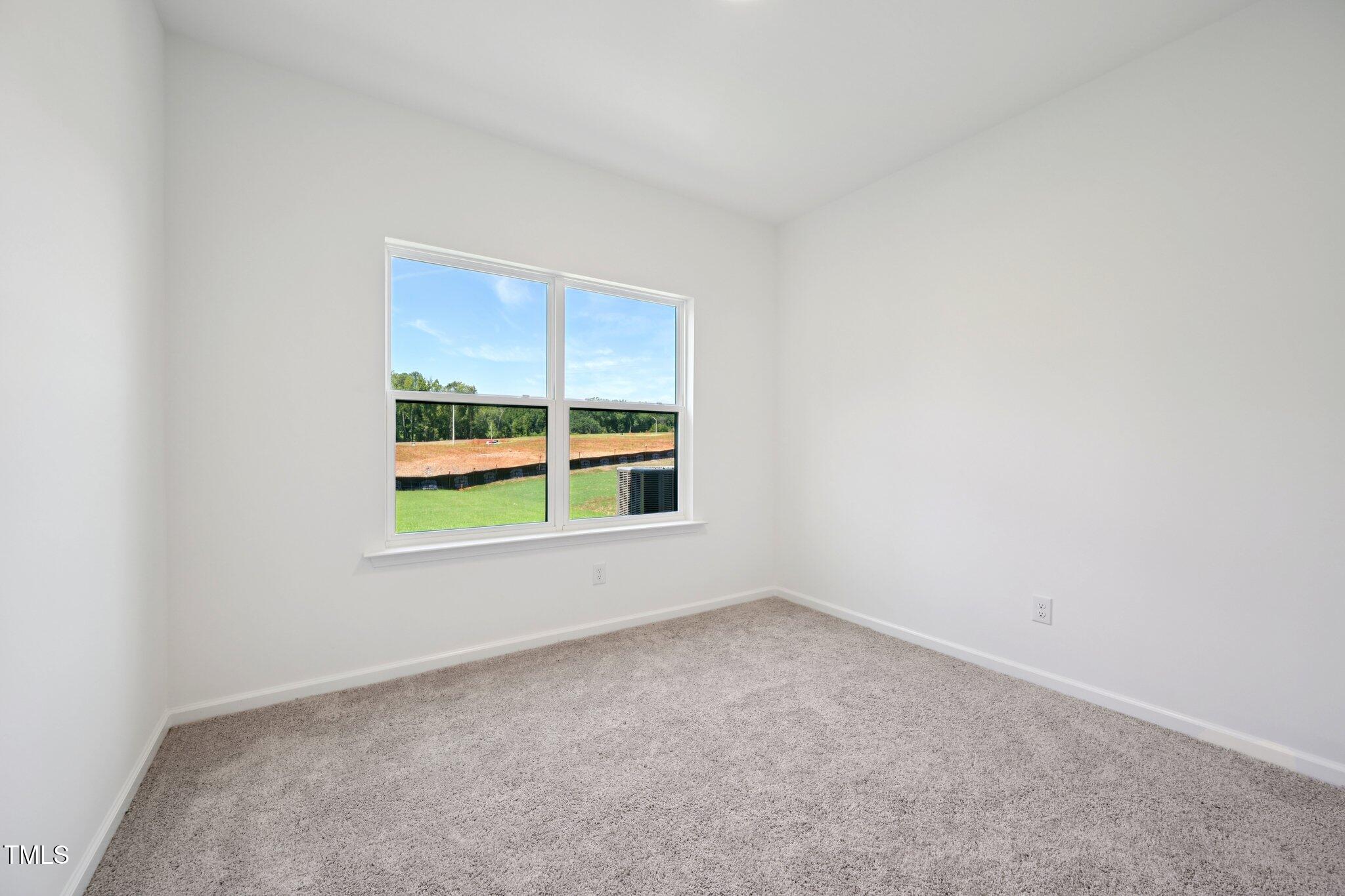 1609 Malcus Court, Unit 67 Fuquay-Varina, NC 27526 - Photo 19 of 40 an empty room with a window