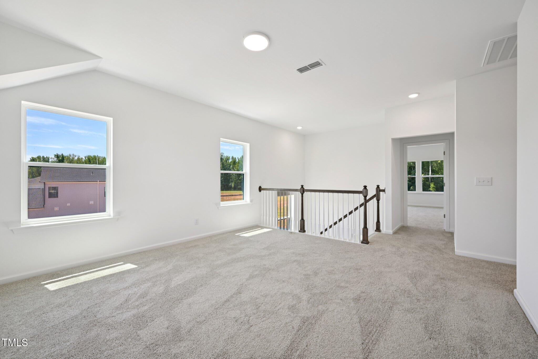 1609 Malcus Court, Unit 67 Fuquay-Varina, NC 27526 - Photo 22 of 40 a view of an empty room with a window