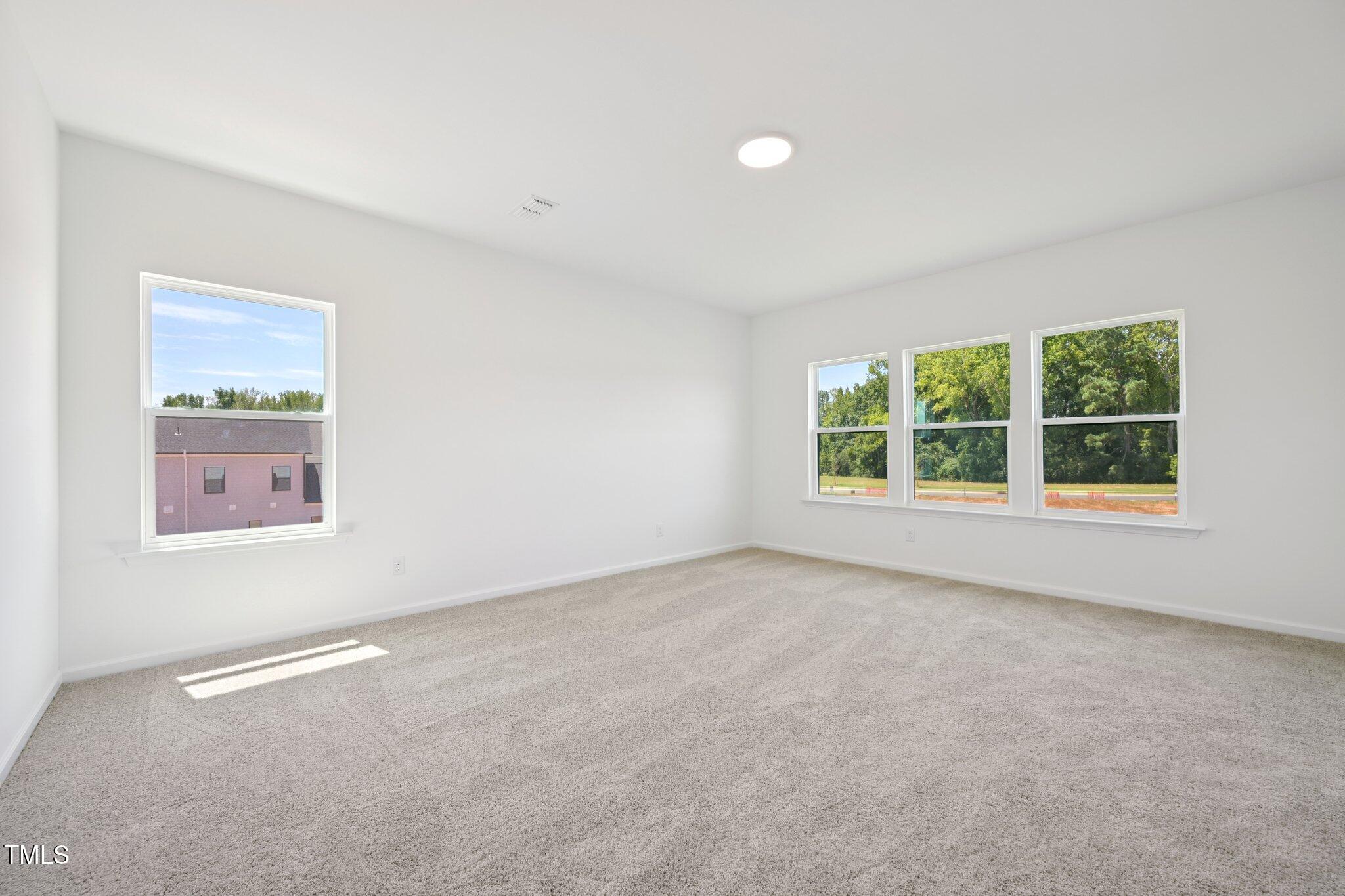 1609 Malcus Court, Unit 67 Fuquay-Varina, NC 27526 - Photo 23 of 40 an empty room with windows