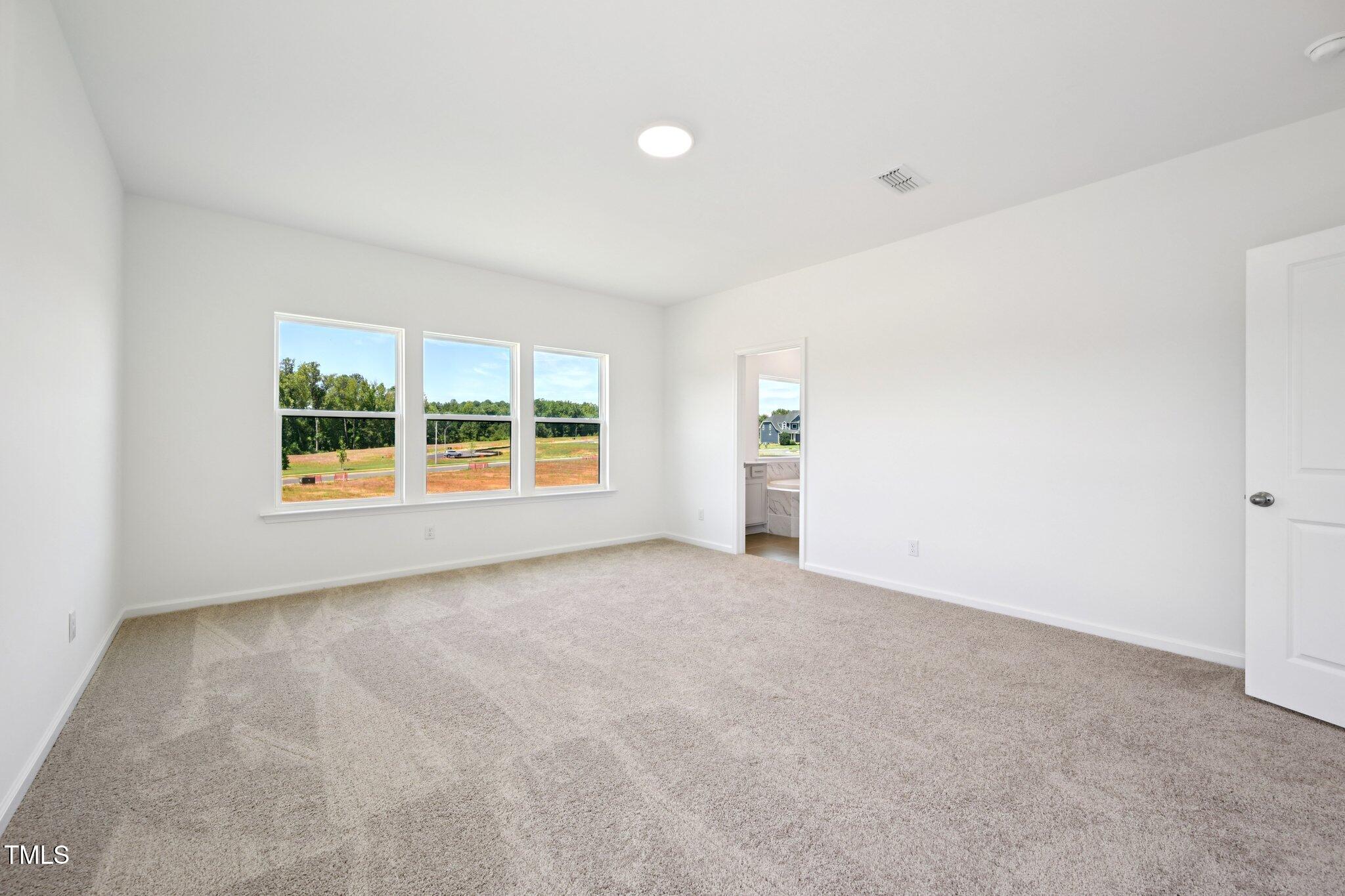 1609 Malcus Court, Unit 67 Fuquay-Varina, NC 27526 - Photo 24 of 40 an empty room with windows