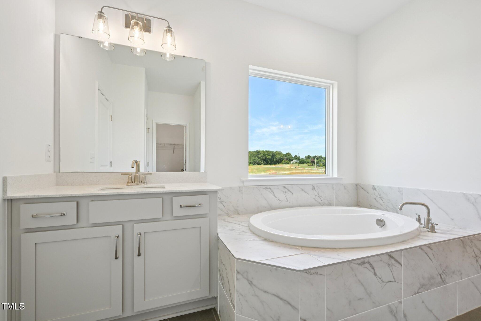 1609 Malcus Court, Unit 67 Fuquay-Varina, NC 27526 - Photo 25 of 40 a bathroom with a sink and a mirror